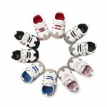 Assorted baby shoes with different color patterns on a white background