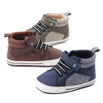 Three pairs of children's high-top shoes in brown, gray, and blue on a white background.