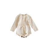 Cream-colored knitted baby romper on a white background
