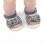 Baby sandals with checkered bows on a white background