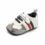 Baby shoe with gray, white, and red design on a white background