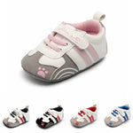 Set of baby shoes with paw prints on a white background
