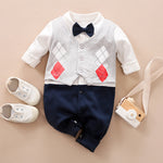 Children's outfit with vest, shirt, pants, shoes, and camera on a beige background