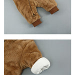 Brown fuzzy onesie with white cuffs on a gray background