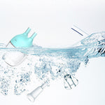 Clear water with a blue funnel and white bottles on a light gray background