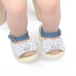 Children's sandals with polka dot pattern and denim straps on a white background
