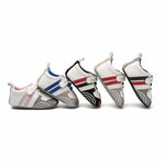 Four pairs of baby shoes with different color patterns on a white background
