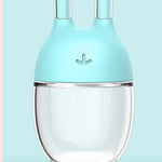 Clear container with blue lid on a light blue background