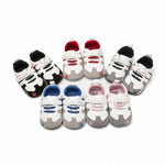 Set of baby shoes with different color combinations on a white background