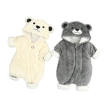 Two baby rompers, one white and one gray, with bear face designs on a gray background.